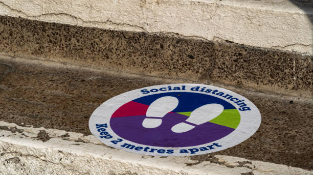 istock Colourful social distancing sticker on steps outside of a building 1282276896