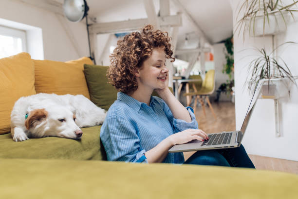 istock Happy girl working from her living room 1282276942