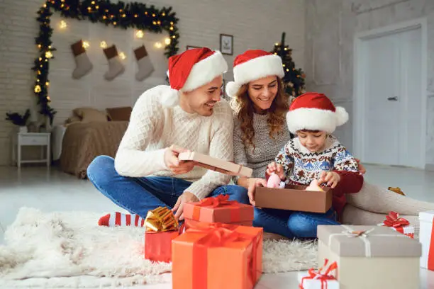 Photo of Family gives  gifts to the child  at home for Christmas.