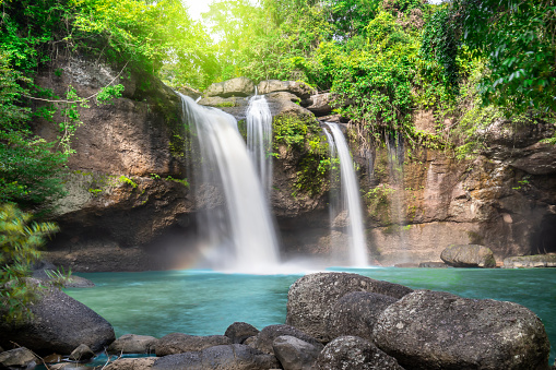Travel to the beautiful waterfall in deep forest, soft water of the stream in the natural park at Haew Suwat Waterfall at Khao Yai National Park, Thailand
