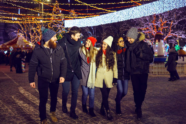 istock Friends have fun walking on Christmas streets at night. 1282277977