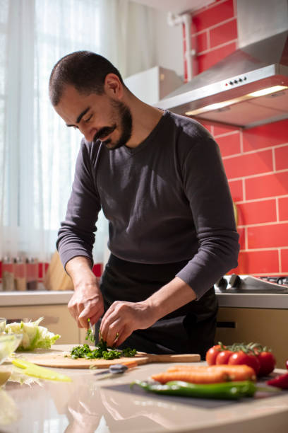 istock Man Cutting Fresh Parsley  at the Kitchen 1282278537