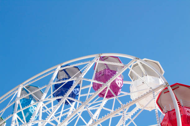 istock Ferris wheel with multi-colored cabs on a background of blue sky 1282279948
