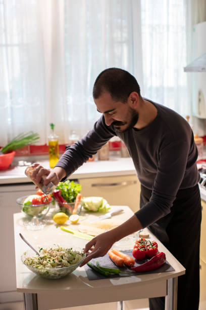 istock Man Putting Spice on the Salad 1282280580
