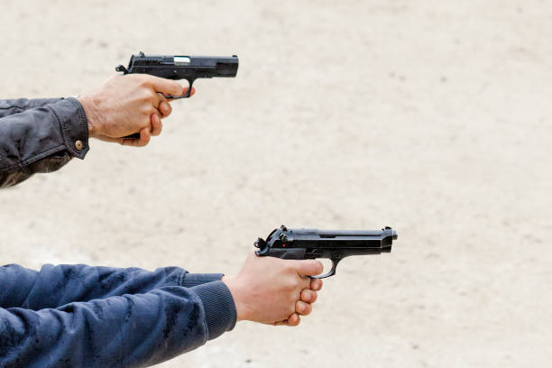 istock Two people are shooting with pistols 1282280691