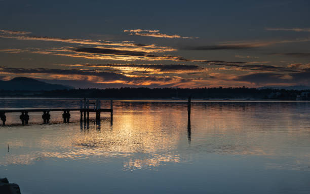 istock Clouds, reflections and sunrise over the bay 1282281744