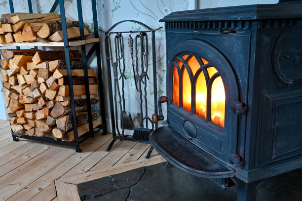 istock cast iron stove with fire and stacked wood beside 1282281977