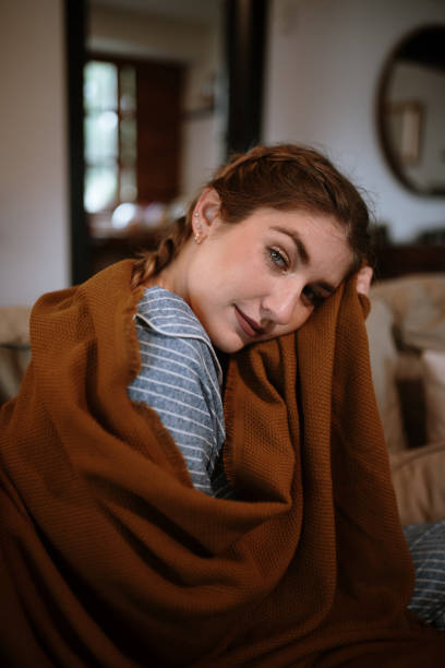 istock Young woman with a blanket and pajamas 1282282089