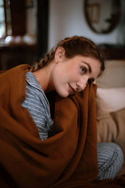 istock Young woman with a blanket and pajamas 1282282242