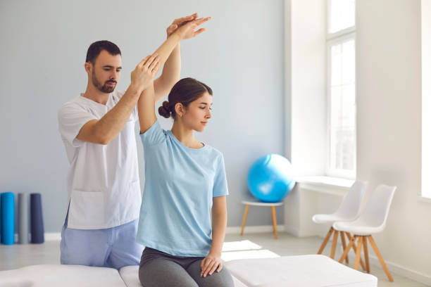istock Licensed chiropractor or physiotherapist examining young woman's arm in modern clinic 1282282476