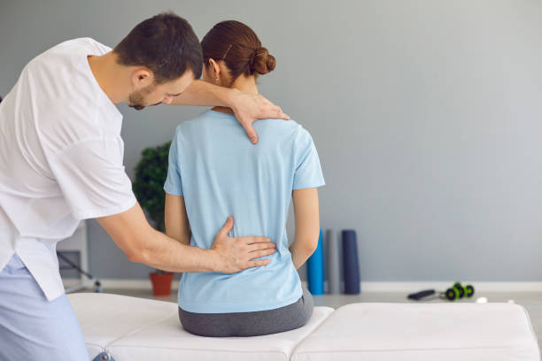 istock Professional osteopath fixing woman patients back muscles during rehabilitation theapy 1282282478