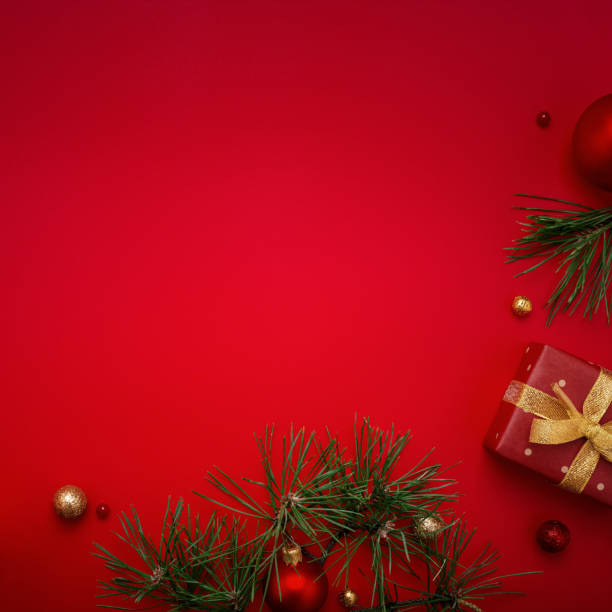 istock Red Christmas background with gift and fir tree on copy space. 1282283363