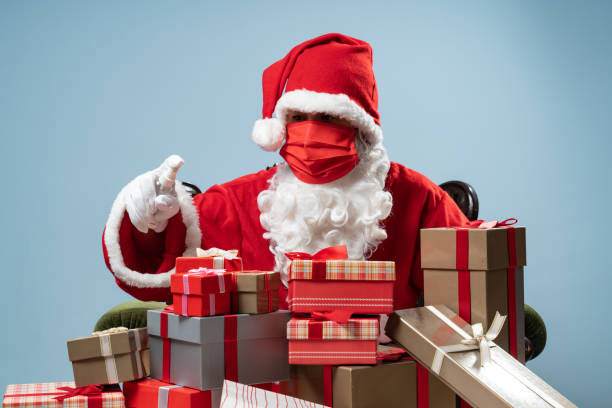 istock Santa Claus Wearing Protective Gloves Disinfecting Gift Box For Christmas 1282287710