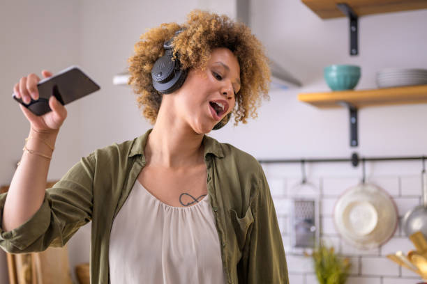 istock Mixed race girl with headphones expressing her emotions through singing 1282289065