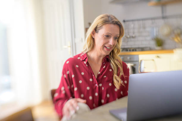 istock Smiling Caucasian woman communicating with colleagues through video call 1282289082