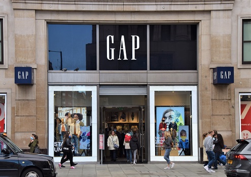 London, United Kingdom - October 25 2020: People walk past the Gap store on Oxford Street, daytime street view