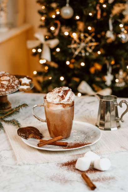 istock Cozy Christmas Hot Chocolate with marshmallowss, cookies and christmas tree 1282290392