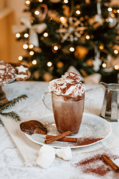 istock Cozy Christmas Hot Chocolate with marshmallowss, cookies and christmas tree 1282290858
