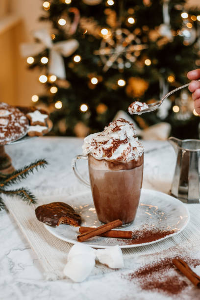 istock Cozy Christmas Hot Chocolate with marshmallowss, cookies and christmas tree 1282290961