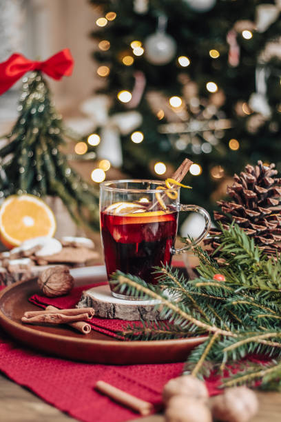 Christmas Mulled Wine Glühwein with spices and christmas tree Christmas Mulled Wine Glühwein with spices and christmas tree sprinkling powdered sugar stock pictures, royalty-free photos & images