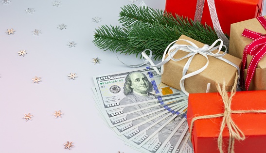 Gift boxes with Christmas decoration and American dollar bills