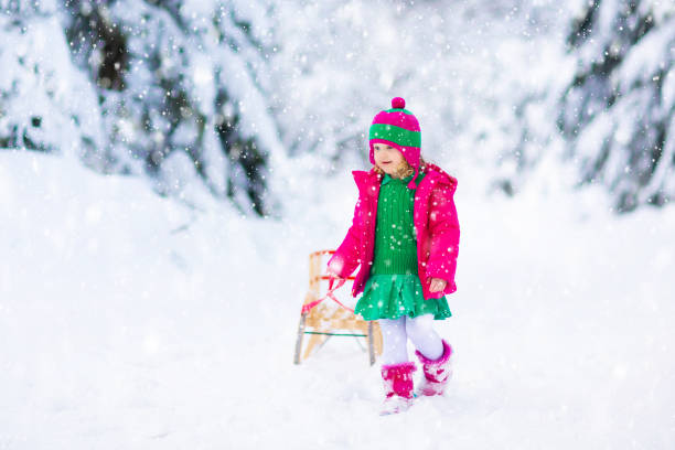 istock Girl on sled ride. Child sledding. Kid on sledge 1282291515