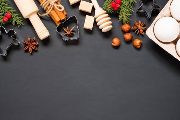 istock Forms and ingredients for making christmas cookies on a black background with copy space 1282291722