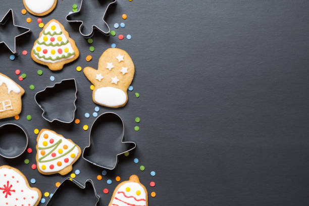 istock Forms for cooking and christmas cookies on black background with copy space 1282291779