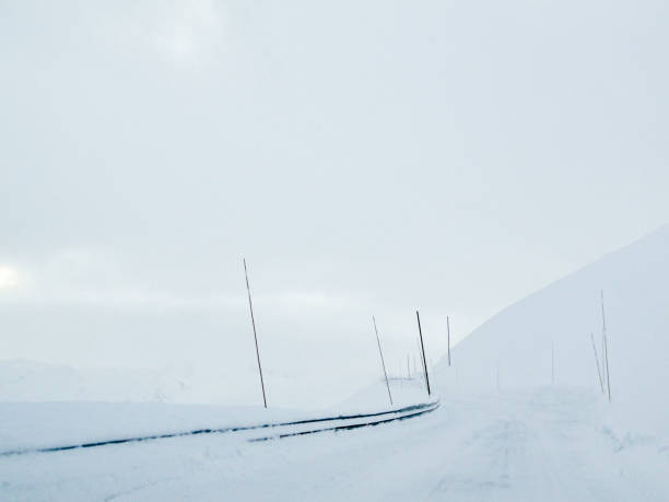 istock Driving through snowy white road and landscape in Norway. 1282292881