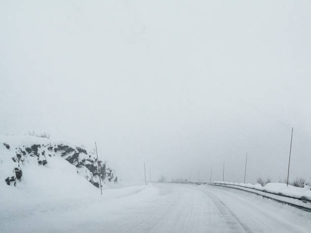 istock Driving through snowy white road and landscape in Norway. 1282292893