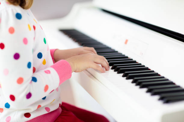 istock Child playing piano. Kids play music. 1282293080
