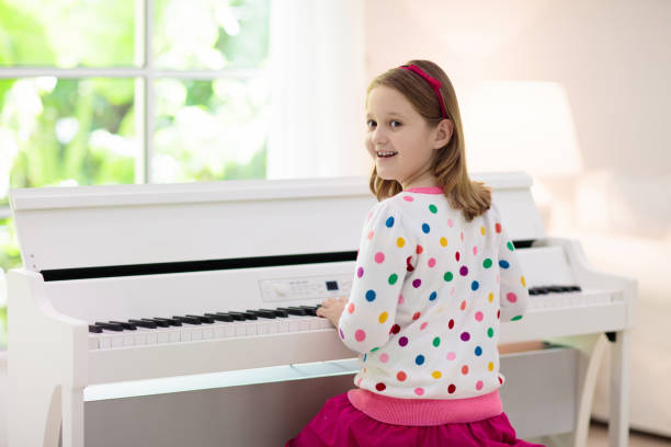 istock Child playing piano. Kids play music. 1282293167
