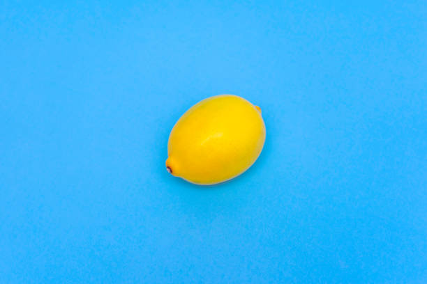 Lemon isolated on blue background stock photo