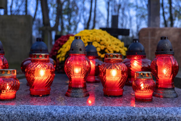 istock Evening Candle Lights On Cemetery Grave 1282293912