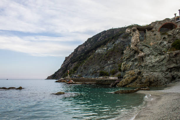 Monterosso al Mare, Italy - July 8, 2017: View of Il Gigante Statue on Fegina Beach on a Summer Day