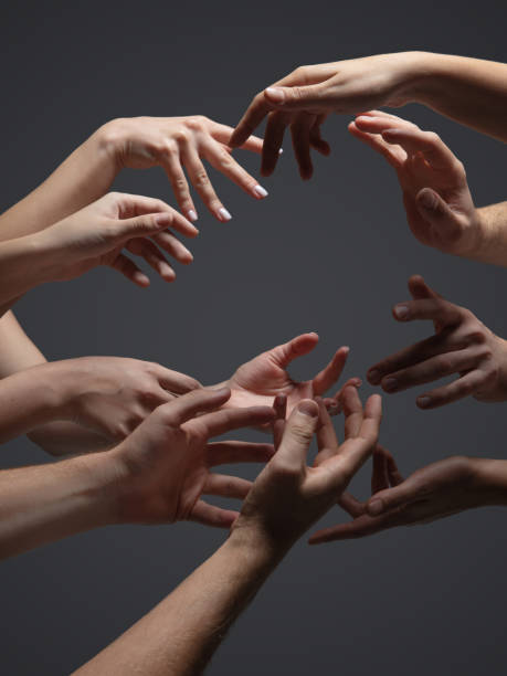 istock Hands of people's crowd in touch isolated on grey studio background. Concept of human relation, community, togetherness, symbolism 1282298438