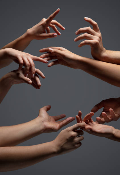istock Hands of people's crowd in touch isolated on grey studio background. Concept of human relation, community, togetherness, symbolism 1282298440