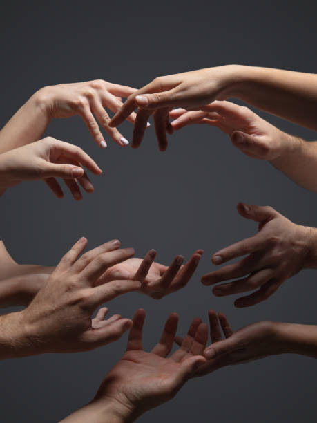 istock Hands of people's crowd in touch isolated on grey studio background. Concept of human relation, community, togetherness, symbolism 1282298443