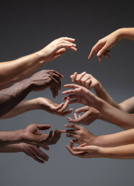 istock Hands of people's crowd in touch isolated on grey studio background. Concept of human relation, community, togetherness, symbolism 1282298479