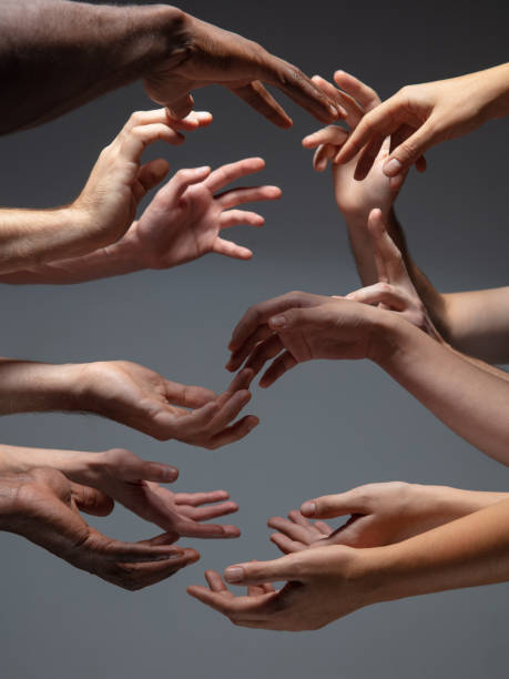 istock Hands of people's crowd in touch isolated on grey studio background. Concept of human relation, community, togetherness, symbolism 1282298484