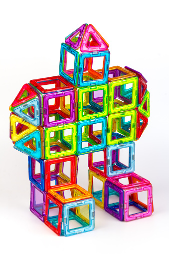 Magnetic designer for development of motor skills, thinking and imagination. Construction assembled from multi-colored parts of children's magnetic designer.