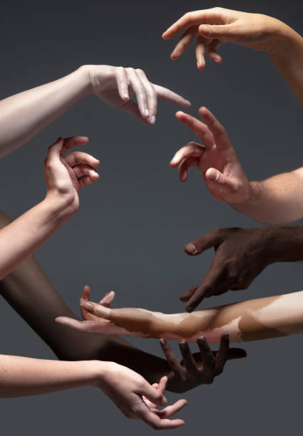 istock Hands of different people in touch isolated on grey studio background. Concept of human relation, community, togetherness, inclusion 1282300190