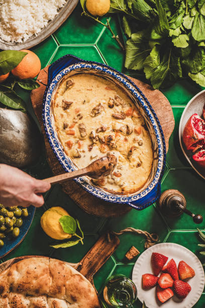 istock Female hands stirring Turkish lamb in sauce over green table 1282300418