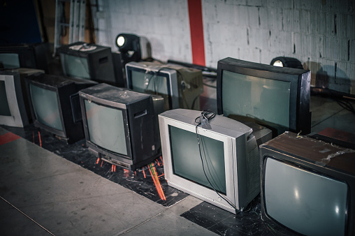 Many old TV wall piled together, pattern, retro television filter style
