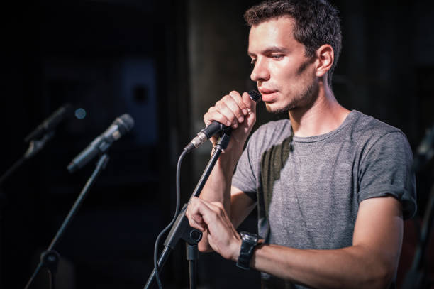 istock Theater audio technician adjusting an microphones on the scene 1282301281