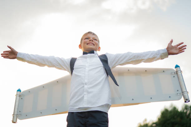 istock Boy in jetpack wings playing on a meadow 1282302633