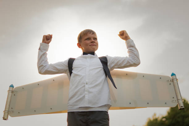 istock Boy in jetpack wings playing on a meadow 1282302725