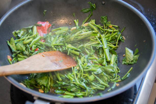"Pad Pak Boong" a traditional Thai dish: stir fried "Morning Glory" vegetables (Ipomoea aquatica) grilled in a wok stock photo