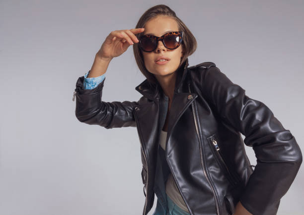istock Confident fashion model looking into distance while wearing sunglasses 1282303340