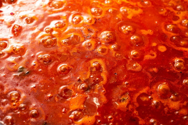 background of boiling tomato sauce background of boiling tomato sauce boiling photos stock pictures, royalty-free photos & images